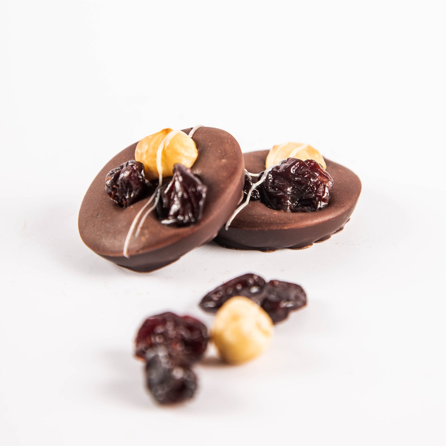 Mendiants with caramel and 72.5% dark chocolate, hazelnuts, cherries and basil