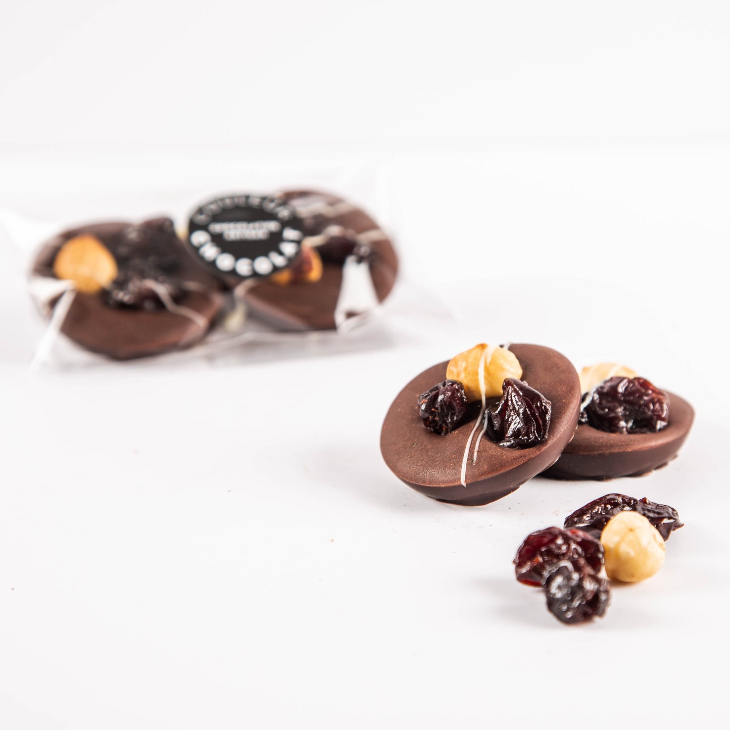 Mendiants with caramel and 72.5% dark chocolate, hazelnuts, cherries and basil